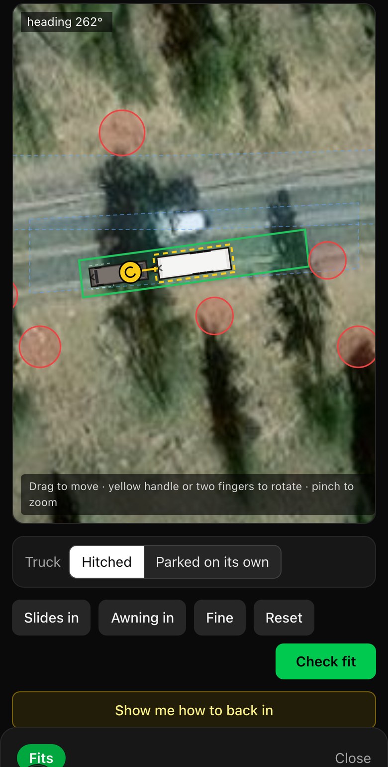 Fit Check on a Rocky Mountain campsite. The trailer and truck sit inside the green pad and the verdict reads Fits.